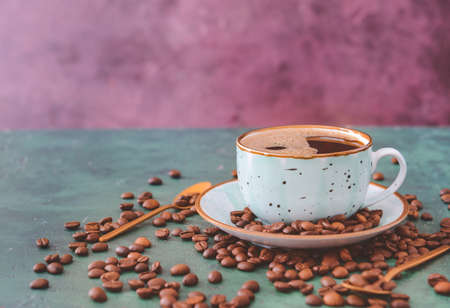 Cup of hot coffee and beans on tableの写真素材