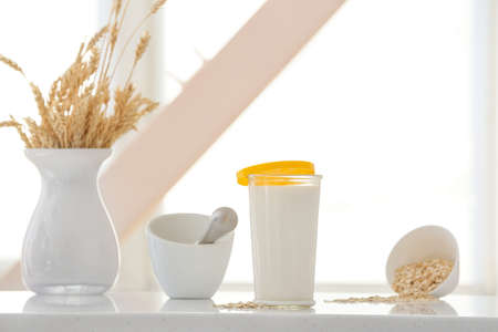 Glass of tasty oat milk on tableの写真素材