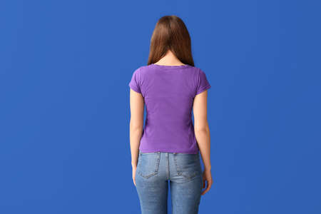 Young woman in stylish t-shirt on color backgroundの写真素材