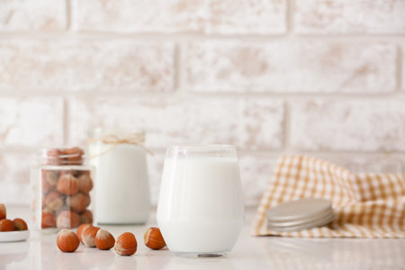 Glass of tasty hazelnut milk on tableの写真素材