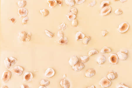 Tasty white chocolate with nuts as backgroundの写真素材