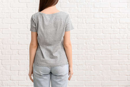 Young woman in stylish t-shirt on white backgroundの写真素材