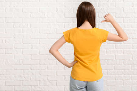 Young woman in stylish t-shirt on white backgroundの写真素材