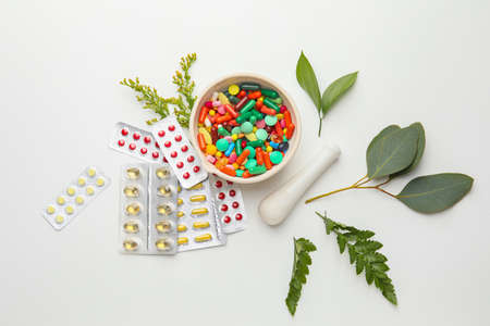 Plant based pills with mortar on white backgroundの写真素材