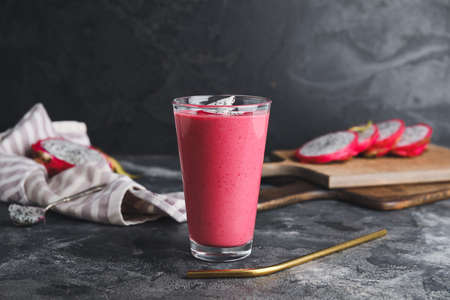 Glass of dragon fruit smoothie on dark backgroundの写真素材