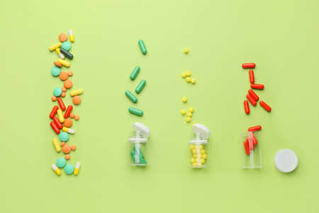 Bottles with different pills on color backgroundの写真素材