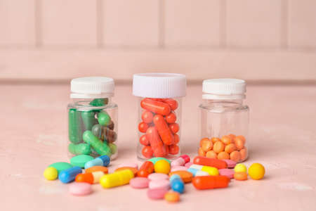 Bottles with different pills on color backgroundの写真素材