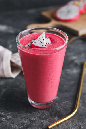 Glass of dragon fruit smoothie on dark backgroundの写真素材