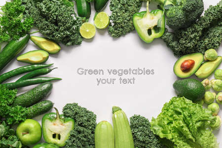 Green vegetables on white background with space for textの写真素材
