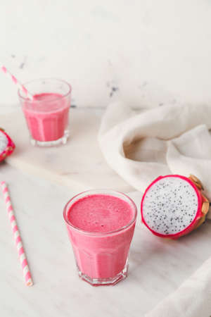 Glass of dragon fruit smoothie on white backgroundの写真素材