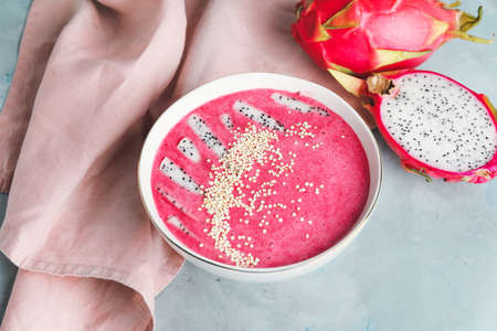 Bowl with dragon fruit smoothie on color backgroundの写真素材