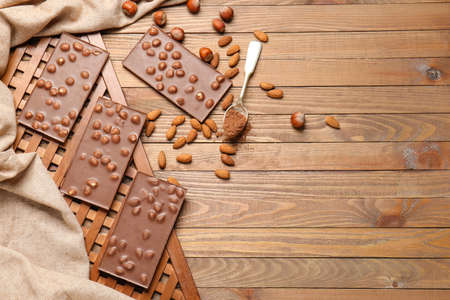 Sweet chocolate with nuts on wooden tableの写真素材