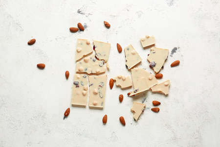 Sweet white chocolate with nuts on table