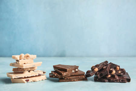 Sweet chocolate with nuts on color table