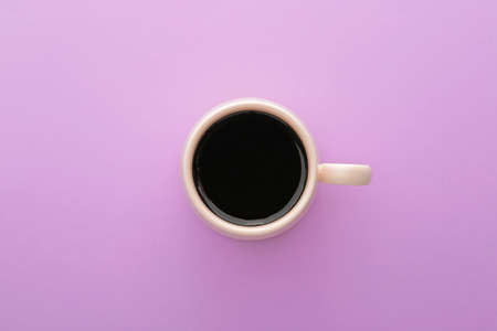 Cup of hot coffee on color background, top viewの写真素材