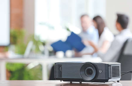 Video projector on table in conference hall