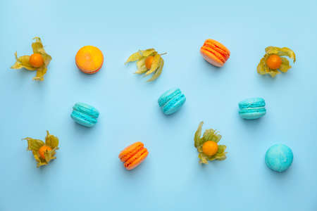 Tasty macarons with fruit on color backgroundの写真素材