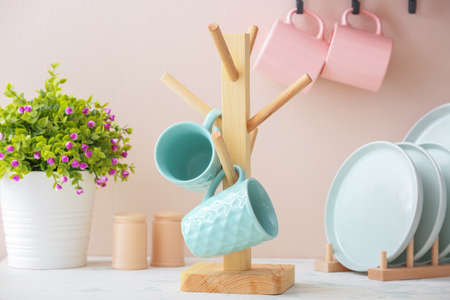 Holder with cups on kitchen tableの写真素材