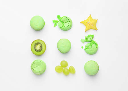 Tasty macarons with fruits on white backgroundの写真素材