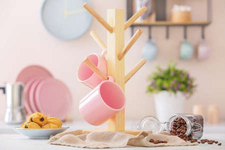 Holder with cups on kitchen tableの写真素材