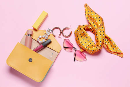 Stylish bag with female accessories on color backgroundの写真素材