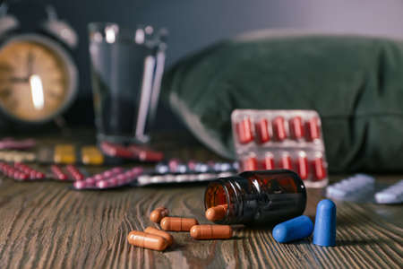 Sleeping pills on wooden tableの写真素材