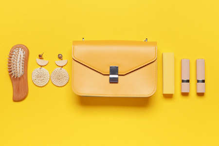 Stylish bag with female accessories on color backgroundの写真素材