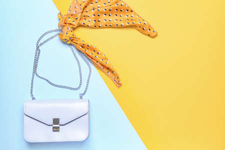 Stylish bag with scarf on color backgroundの写真素材