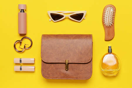 Stylish bag with female accessories on color backgroundの写真素材