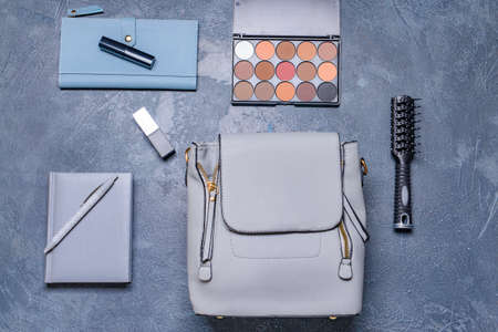 Stylish bag with female accessories on dark backgroundの写真素材