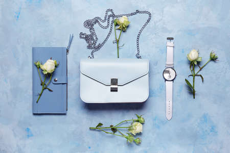 Stylish bag with wrist clock and wallet on color backgroundの写真素材