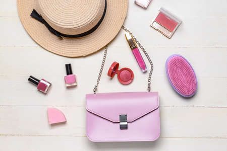 Stylish bag with female accessories on white wooden backgroundの写真素材