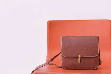 Stylish bag on chair against light backgroundの写真素材