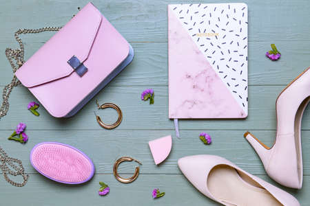 Stylish bag with female accessories and notebook on wooden backgroundの写真素材