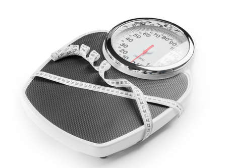 Weight scales with measuring tape on white background. Slimming concept
