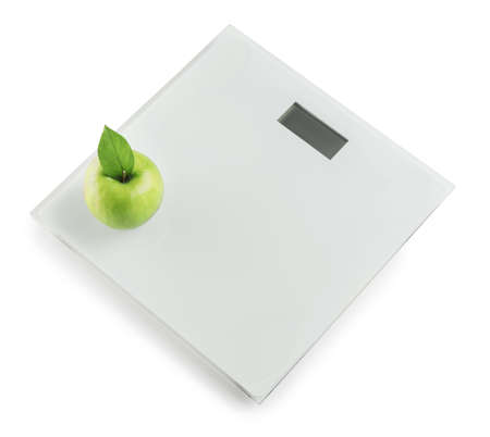 Weight scales with apple on white background. Slimming conceptの写真素材