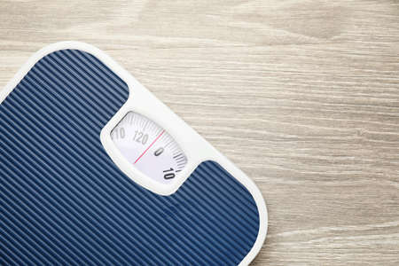Weight scales on wooden background. Slimming conceptの写真素材