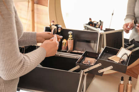 Professional makeup artist with set of decorative cosmetic in caseの写真素材