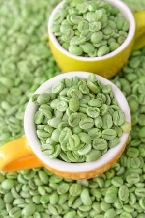Cups with green coffee beans, closeupの写真素材