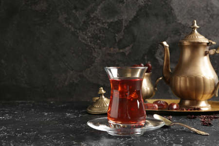 Glass of tasty Turkish tea on dark backgroundの写真素材
