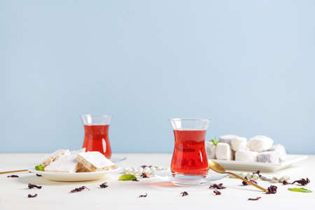 Tasty Turkish tea with sweets on tableの写真素材