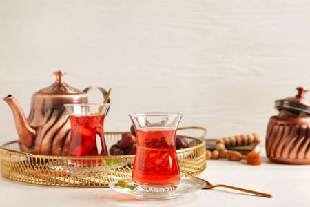Tasty Turkish tea with dates on table