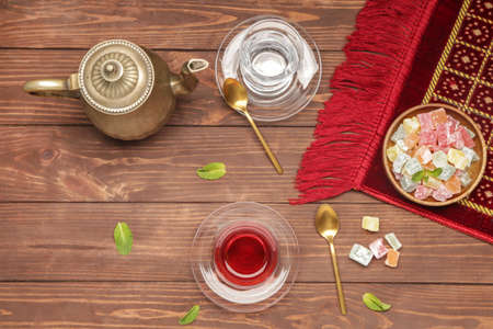 Tasty Turkish tea with sweets on tableの写真素材