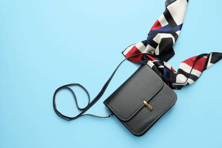 Stylish bag with scarf on color backgroundの写真素材