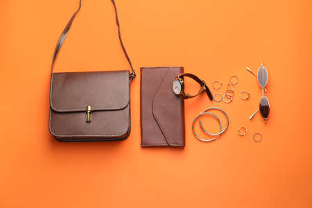 Stylish bag with female accessories on color backgroundの写真素材