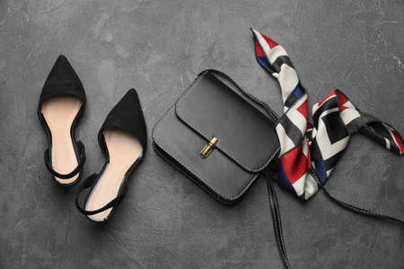 Stylish bag with female shoes on dark backgroundの写真素材