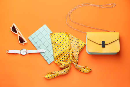 Stylish bag with female accessories on color backgroundの写真素材