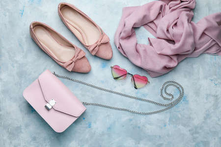 Stylish bag with female accessories on color backgroundの写真素材