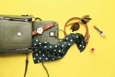 Stylish bag with female accessories on color backgroundの写真素材