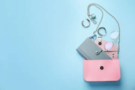 Stylish bag with female accessories on color backgroundの写真素材